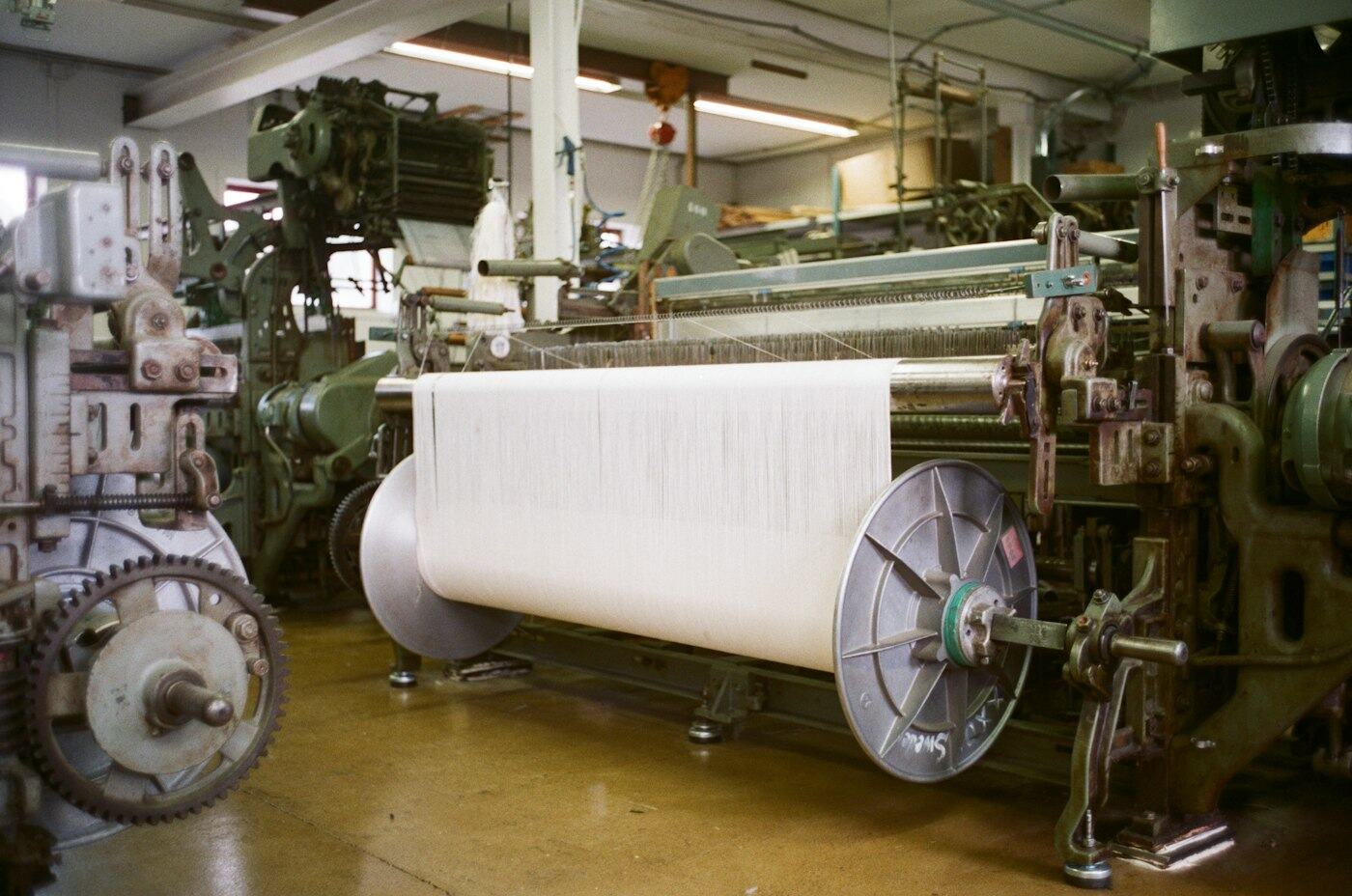 Tufting line producing artificial grass rolls