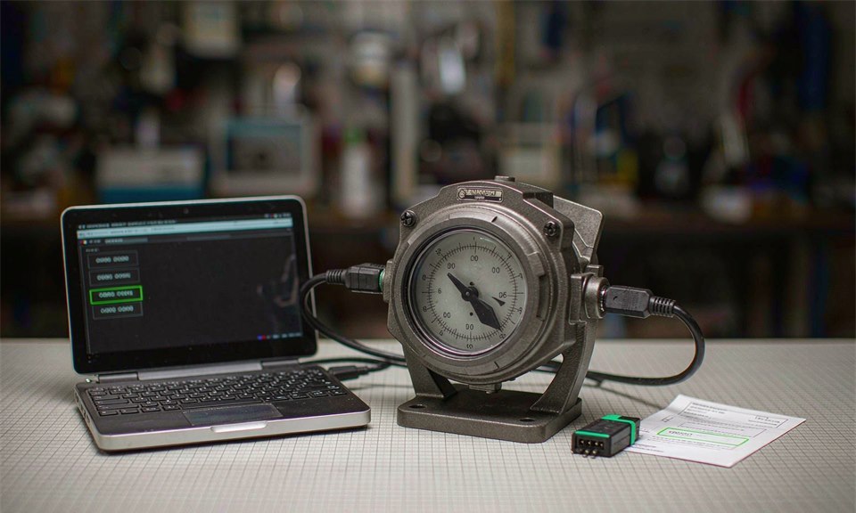 Dial thermometer linked to a laptop during configuration while firmware and limit settings are read back