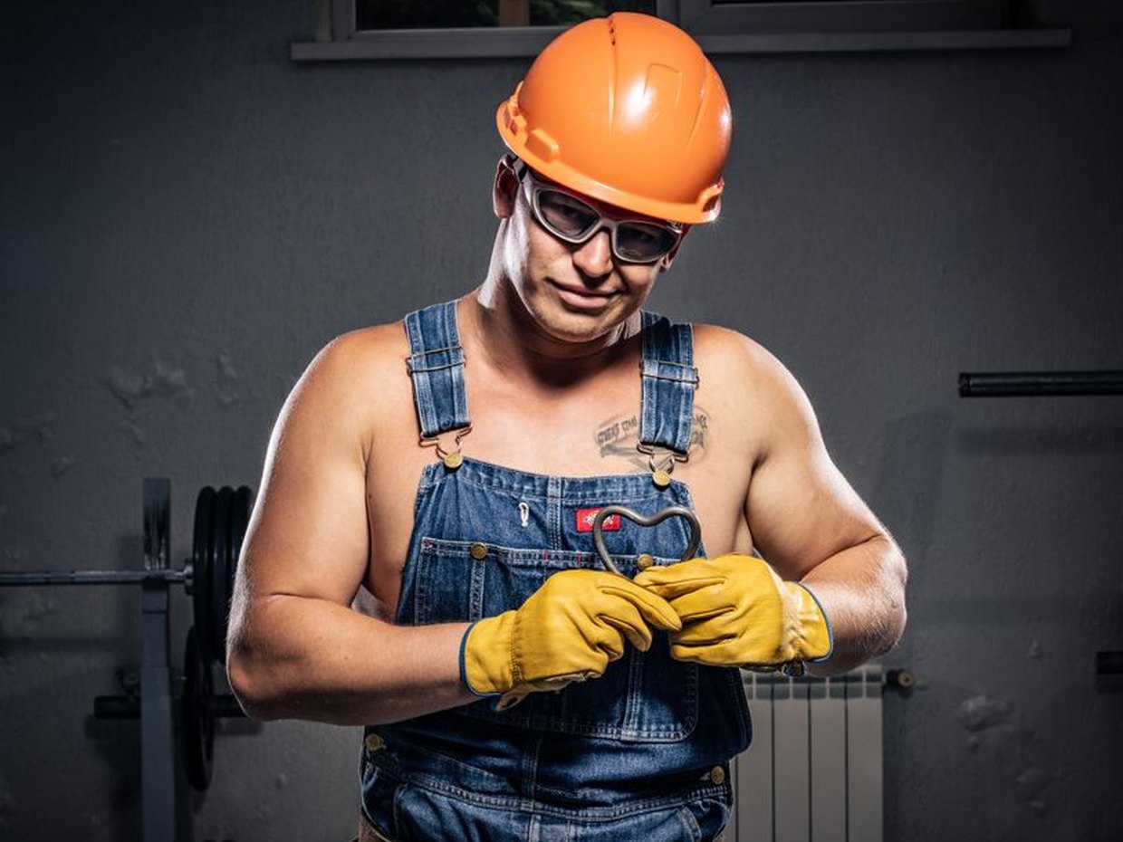 Fitter tightening a threaded pipe connection with a wrench